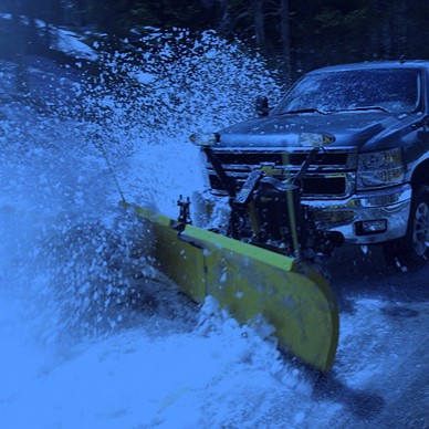 Pickup truck clearing snow on a parking lot